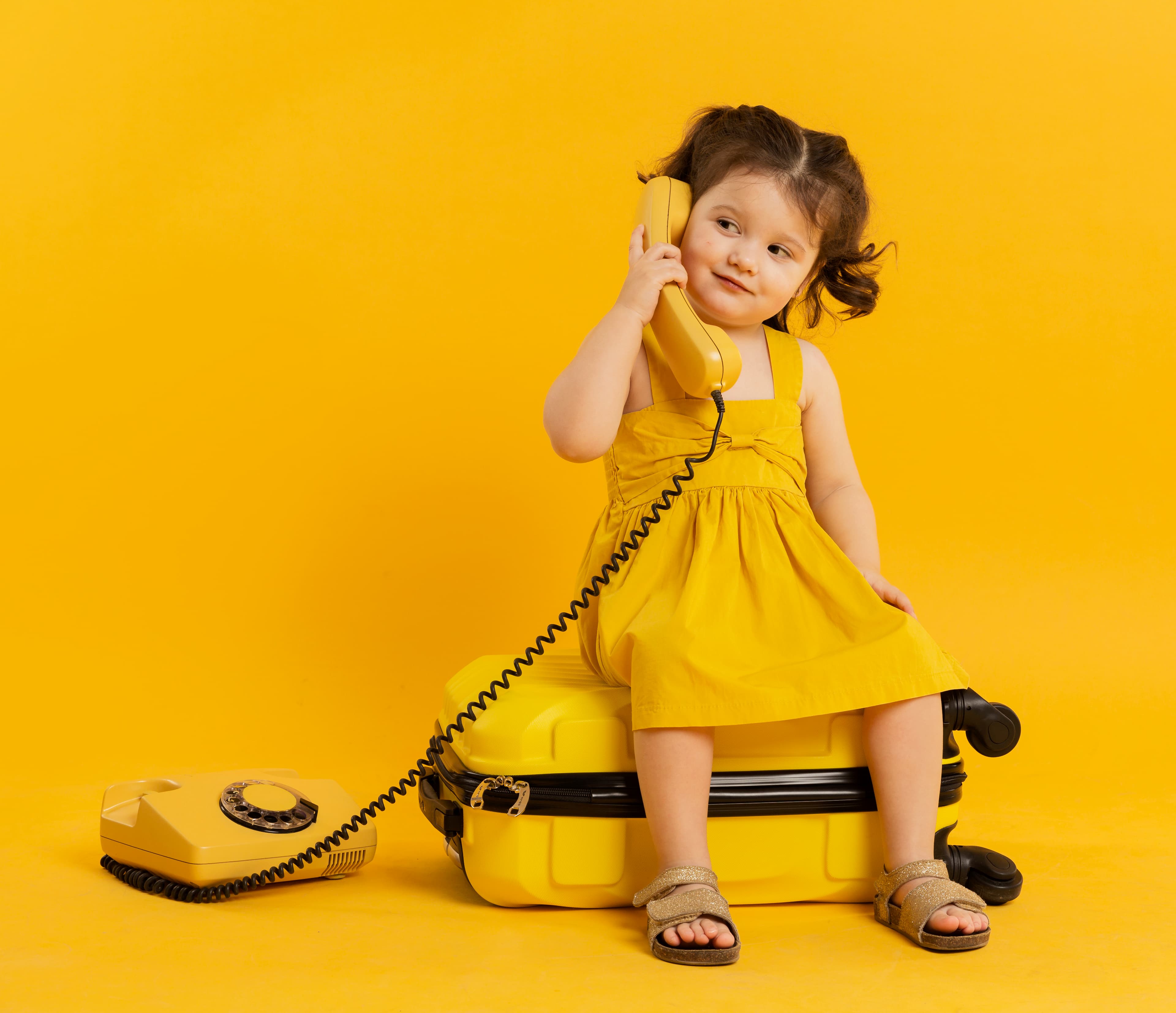 Child with yellow telephone